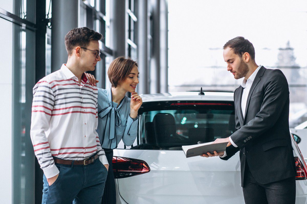 Familia jovem comprando um carro na concessionaria